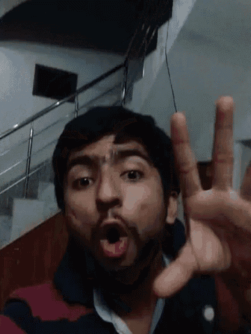 a man with a beard is making a funny face