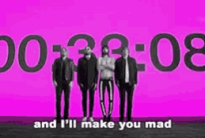 a group of men standing in front of a pink background with the words `` and i 'll make you mad '' written on it .