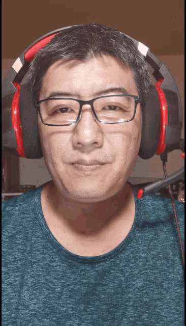 a man wearing glasses and headphones with a microphone
