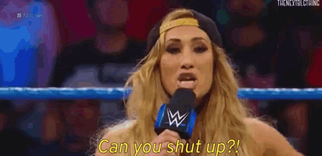 a woman is talking into a microphone in a wrestling ring and says `` miss money in the bank is talking ! ''