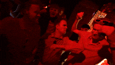 a man in a red shirt is taking a selfie