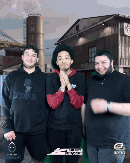 three men are posing for a photo in front of a call of duty league logo
