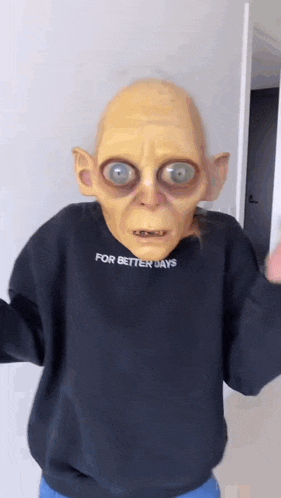 a person wearing a gollum mask and a sweater that says for better days .