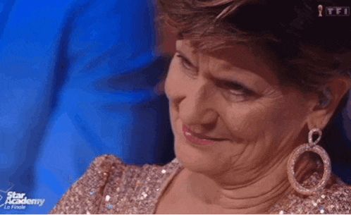 a woman wearing earrings and a sequined dress is on a tv show called star academy la finale