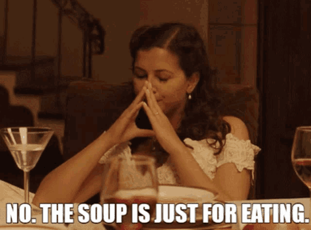 a woman sits at a table with a caption that says " no the soup is just for eating "
