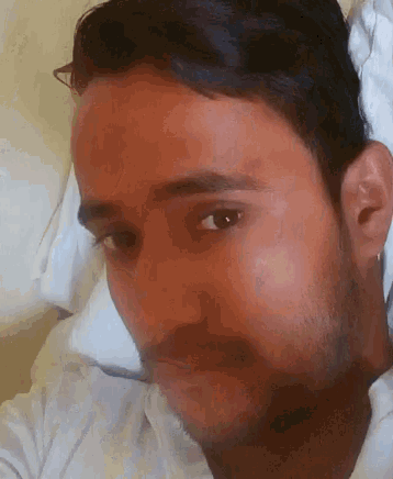 a close up of a man 's face looking at the camera