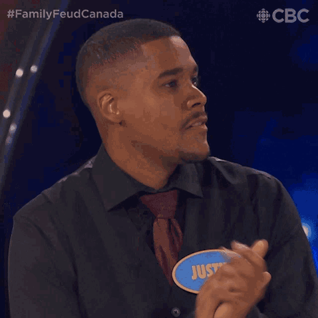 a man wearing a name tag that says justin