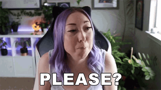 a woman with purple hair is sitting in a chair with the words please written on her face .
