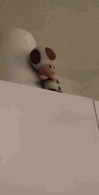 a blurred image of a person standing in a room with clothes on the floor