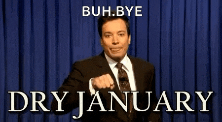 a man in a suit and tie is pointing at the camera with the words " bye dry january " below him .