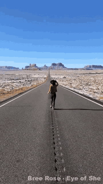 a picture of a woman walking down an empty road with the words bree rose eye of she below her