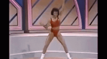 a woman in a red bikini is doing exercises on a tv show .