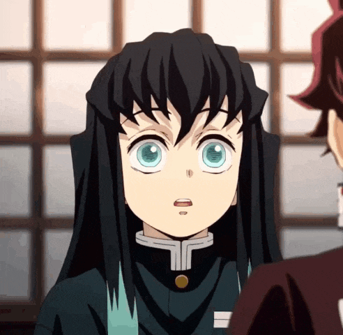 a close up of a person with long black hair and blue eyes looking at another person .
