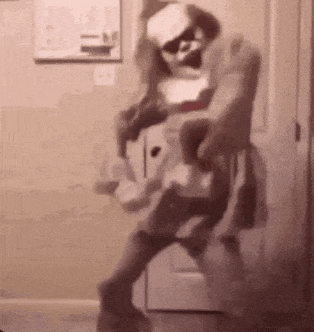 a person in a nurse costume is dancing in a doorway .