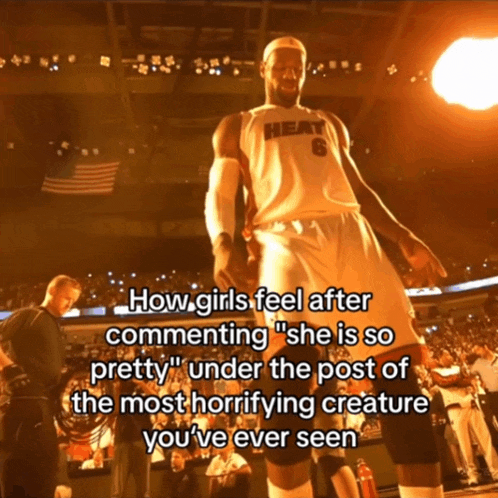 a basketball player in a heat jersey stands on the court