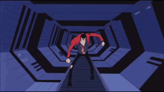 a man in a red jacket is standing on a conveyor belt in a tunnel