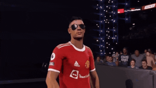 a soccer player wearing sunglasses and a red adidas shirt
