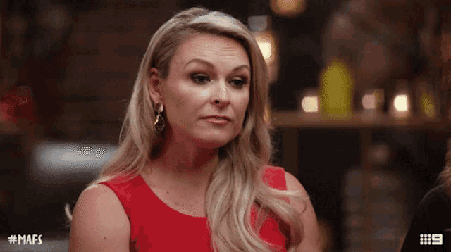 a woman in a red dress has # mafs written on her face