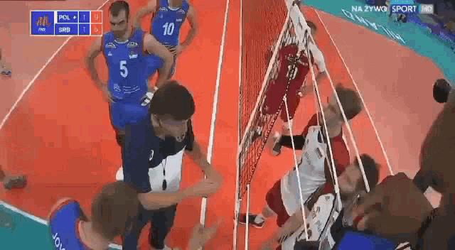 a group of men are playing volleyball on a court and one of them has the number 5 on his jersey