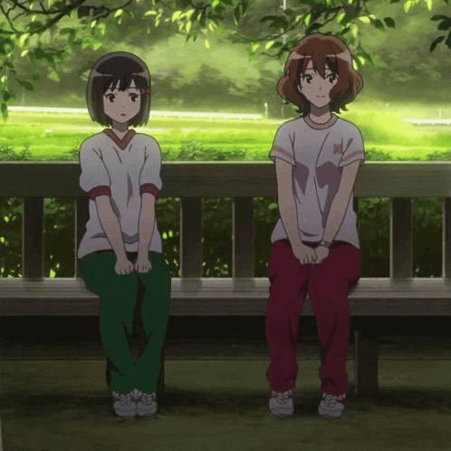 two anime girls are sitting on a bench with one wearing a shirt with a bear on it