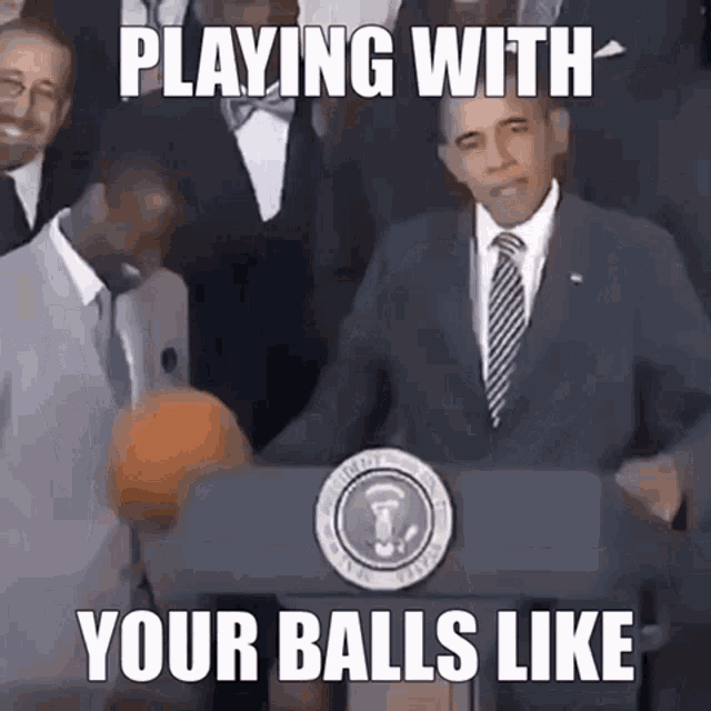 a man in a suit and tie stands behind a podium with the words playing with your balls like written on it