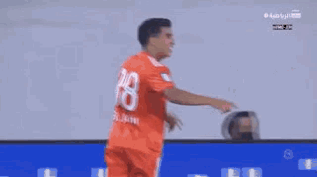 a group of soccer players are standing next to each other on a field .