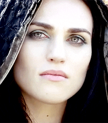 a close up of a woman 's face with a hood