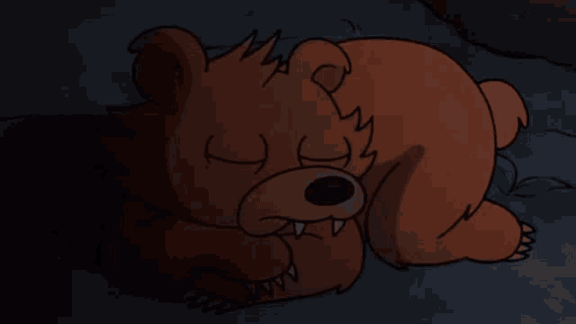 a brown teddy bear is laying down with its eyes closed
