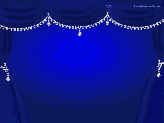 a blue curtain with a necklace of diamonds hanging from the bottom