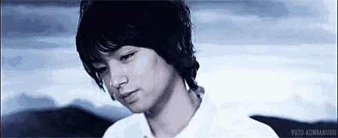 a close up of a young man 's face with a serious look on his face .