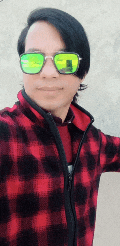 a man wearing sunglasses and a red plaid shirt