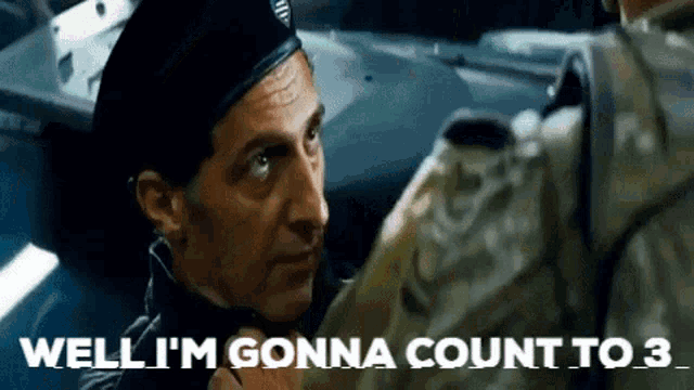a man in a military uniform is talking to another man .