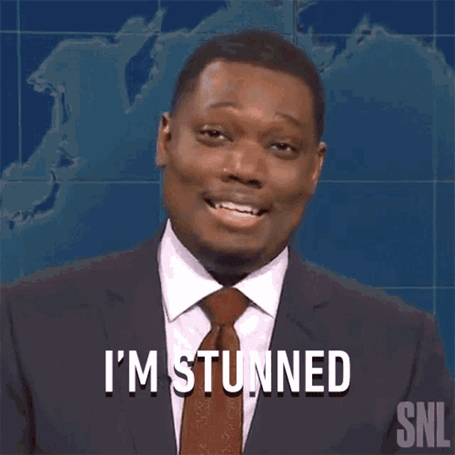 a man in a suit and tie is saying i 'm stunned on snl
