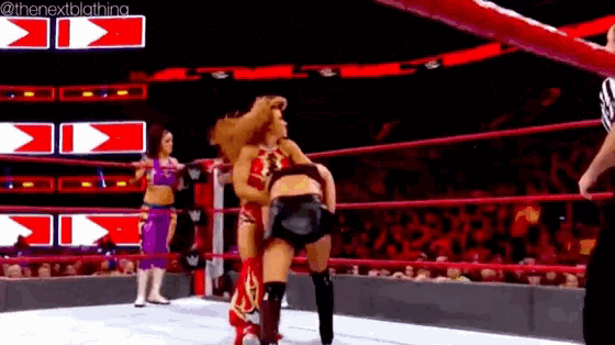 a woman is wrestling another woman in a wrestling ring