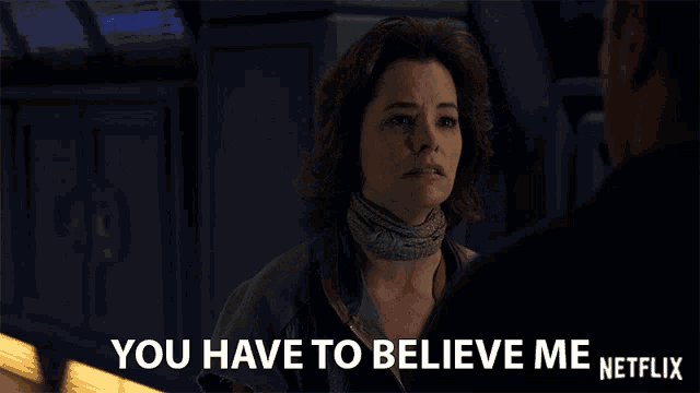 a woman with a scarf around her neck talks to a man with the words you have to believe me netflix below her