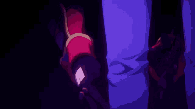a person is standing in a dark room with a purple background