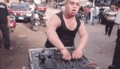 a man with down syndrome is standing in front of a mixer in a crowded street .