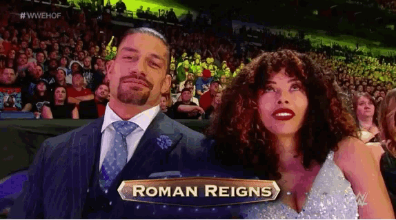 roman reigns and his wife are sitting in the audience