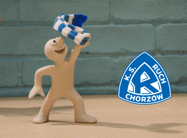 a clay figure holding a blue scarf with a k.s. ruch chorzow logo in the background