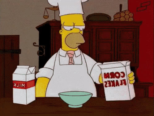 homer simpson is holding a box of corn and a box of milk