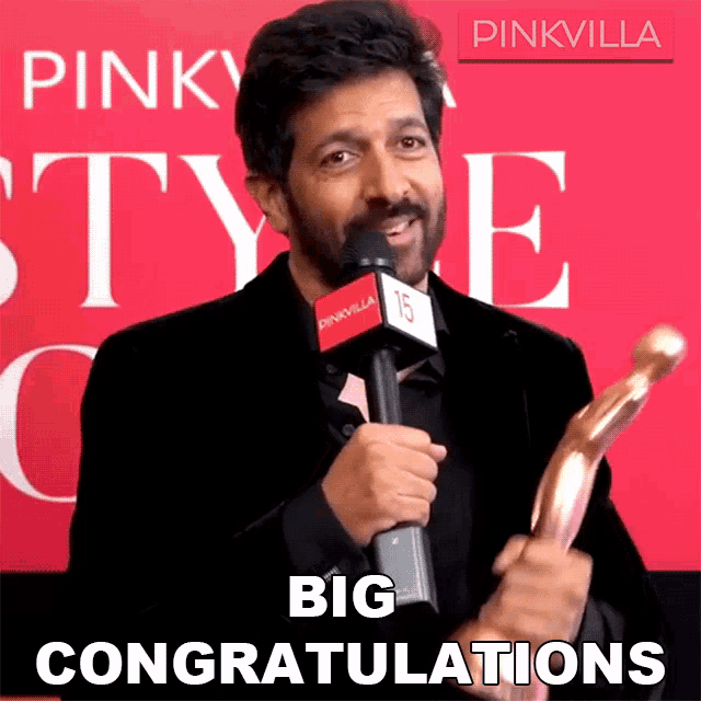 a man holding a trophy with the words big congratulations behind him