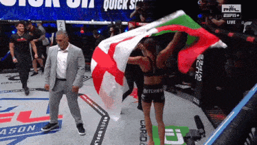 a man in a suit stands next to a woman holding a flag that says quick s