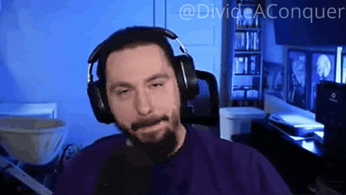 a man wearing headphones and a purple shirt with the words divide aconquer written above him