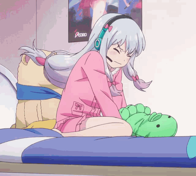 a girl wearing headphones sits on a bed with a stuffed animal