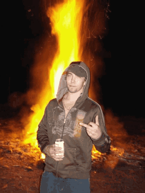 a man standing in front of a fire wearing a hoodie that says samurai on it