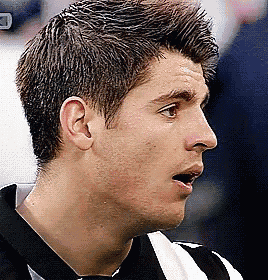 a close up of a man 's face with a black and white striped shirt