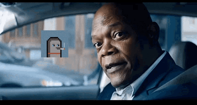 a man in a suit is sitting in a car with a pixelated image of a man smoking a cigarette