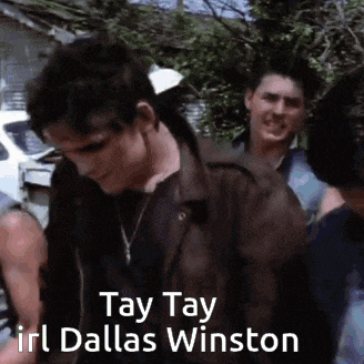 a group of young men are standing next to each other and one of them is wearing a leather jacket .