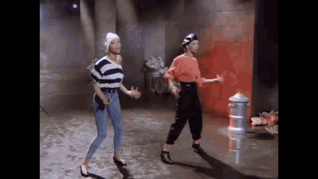 a man and a woman are dancing in a room with a fire hydrant in the background .