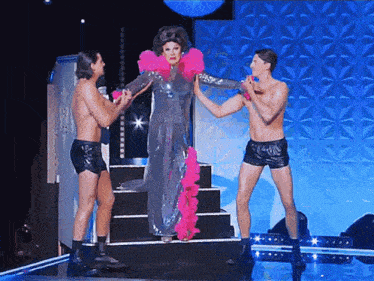 three men are standing around a woman in a dress